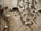 a carving of a face on the side of a wooden door