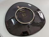 a black plate with a gold ring on top of it