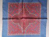 a close up of a red and blue paisley pattern on a blue background