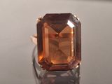 a ring that has a large brown stone on it