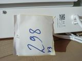 a piece of paper with a blue writing on it sitting next to a computer