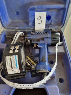 une boîte bleue contenant une perceuse et un cordon