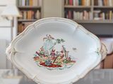 a white plate with a picture of a man and a dog on it