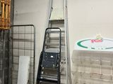 a ladder that is leaning against a wall next to a stack of boxes