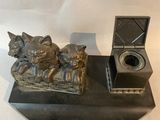 a statue of a cat and a dog on a desk