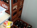 bottles of beer are stacked on top of each other in a room