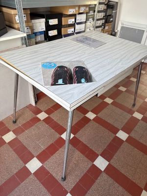 a table with a pair of shoes on it in a room