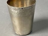 a silver cup that is sitting on a table