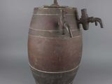 a brown barrel with a faucet attached to it
