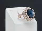 an image of a ring with a blue stone and diamonds