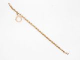a close up of a gold chain bracelet with a ring on it