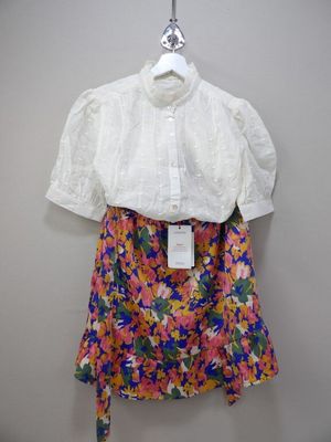 the shirt is white and has colorful flowers on it