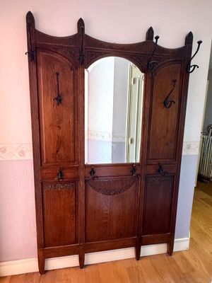 a wooden cabinet with a mirror on top of it