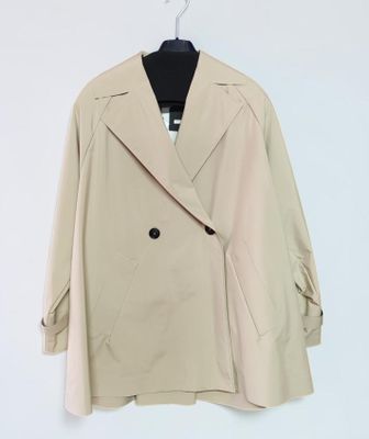 a white coat hanging on a hanger on a wall