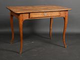 an old wooden table with a drawer on top of it