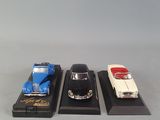 three toy cars on display on a table