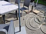 a table and chairs with an umbrella in the backyard