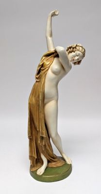 an image of a statue of a woman on a green base