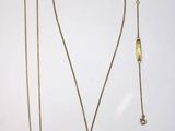 a close up of a necklace and two other items on a table