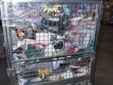 a metal cart with many items in it in a warehouse