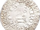 an old silver coin with an image of a man on it