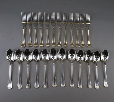a lot of silver spoons and forks on the table