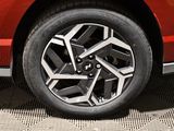 a close up of a red car ' s wheel on the street