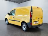 the yellow van is parked in the large room of the building