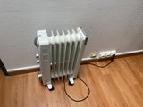 a white radiator sitting on the floor next to a wall