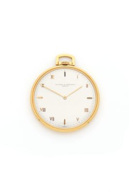 a close up of a gold watch with roman numerals on the face