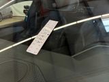 a sticker on the windshield of a car that is in a showroom