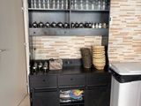 a kitchen with a black cabinet and a sink in it