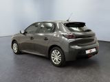 the back of a grey car in a room with a black floor