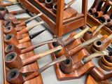 many different types of pipe holders on display