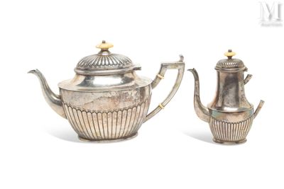 two silver teapots sitting next to each other on a white surface