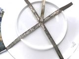 a white plate with a fork and knife on it
