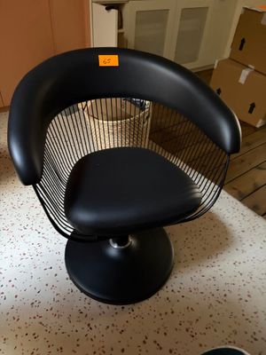a black chair that is sitting on a table
