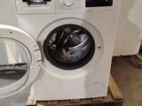 a washing machine sitting on a pallet in a room
