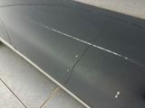 a black car with a hole in the side of it