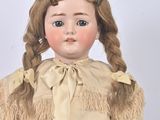 a doll that is wearing a dress and holding a basket