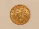 a close up of a gold coin with a woman ' s head on it