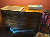 a dresser and a chair in the corner of a room
