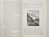 an open book with a picture of a mountain in it