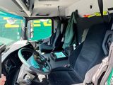 a man that is sitting in the driver seat of a truck