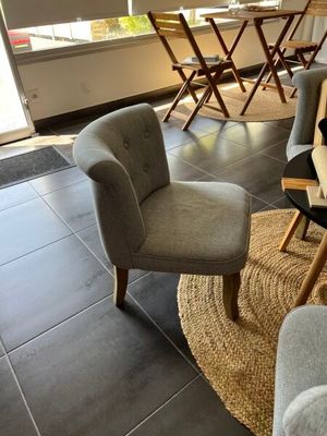 a living room with a couch, chairs, and a table in it