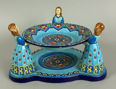 a picture of a blue and gold plate with a woman on it