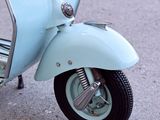 a blue scooter parked on the side of the road