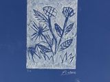 an image of a picture of a bird on a plant in a blue sky