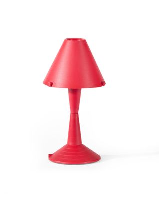 La lampe de table rouge est posée sur une surface blanche, avec un fond blanc.