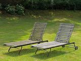 two lawn chairs that are sitting in the grass